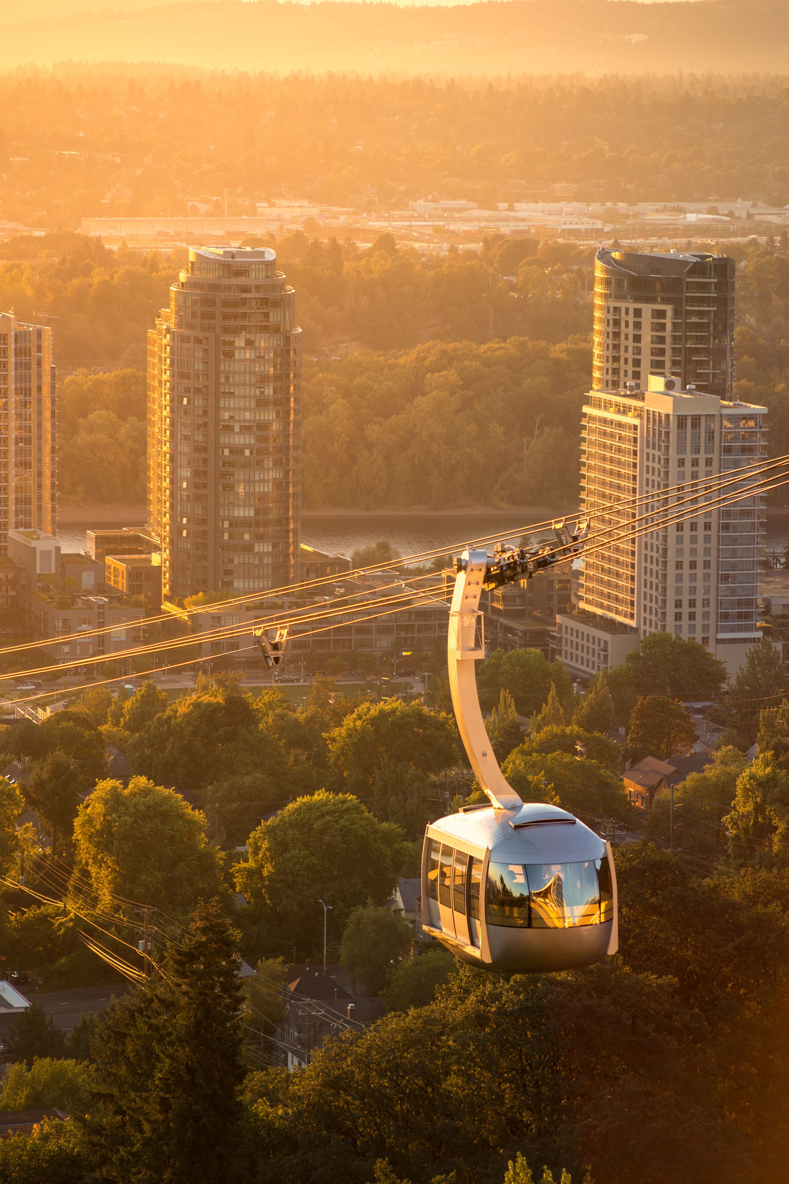 Cable car in Portland, Oregon, USA with wonderful view on sunrise with mt. Hood and aerial tram going to OHSU