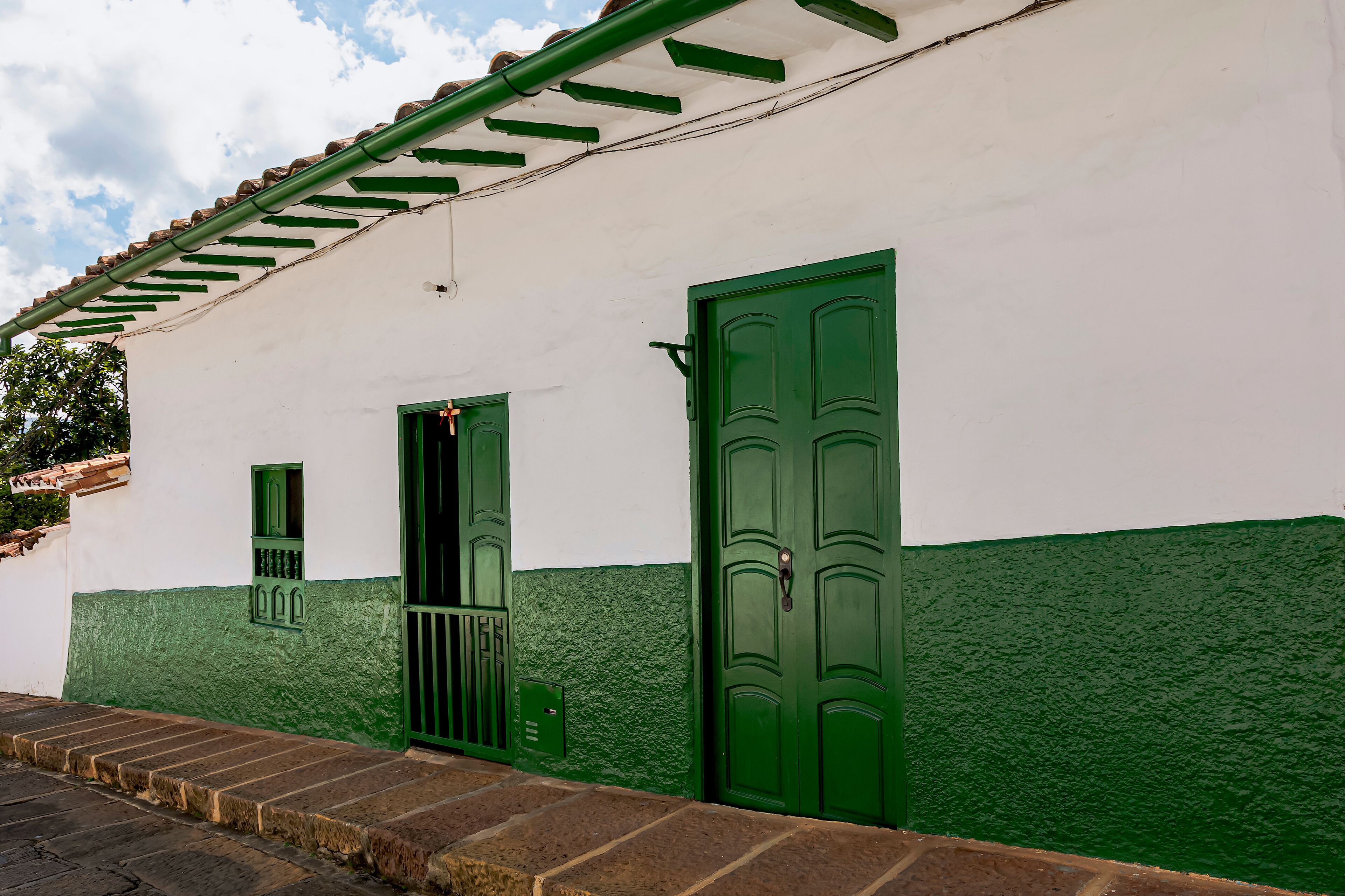 Typical houses with dark green doors and windows.