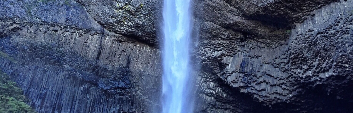 Una cascada que se precipita por un risco cubierto de musgo.