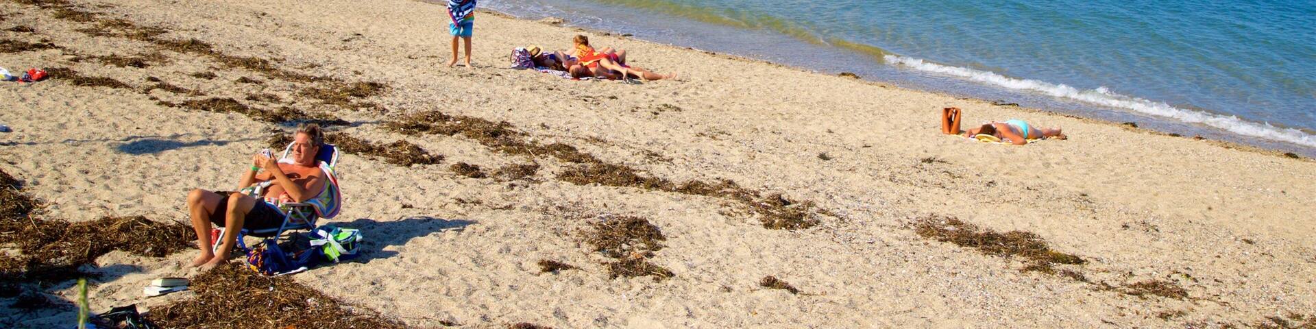 East End Beach which includes a bay or harbor, a beach and general coastal views