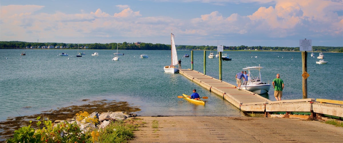 Eastern Promenade which includes a bay or harbour and general coastal views as well as a small group of people