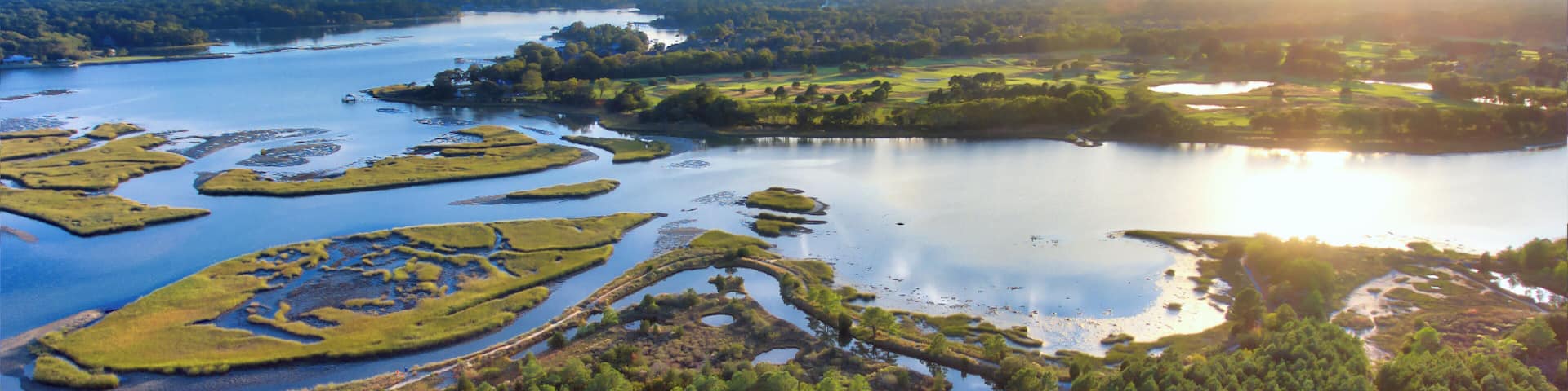 Tidal estuary and wetlands ecosystem near the ocean, Virginia Beach, Virginia at sunset.
