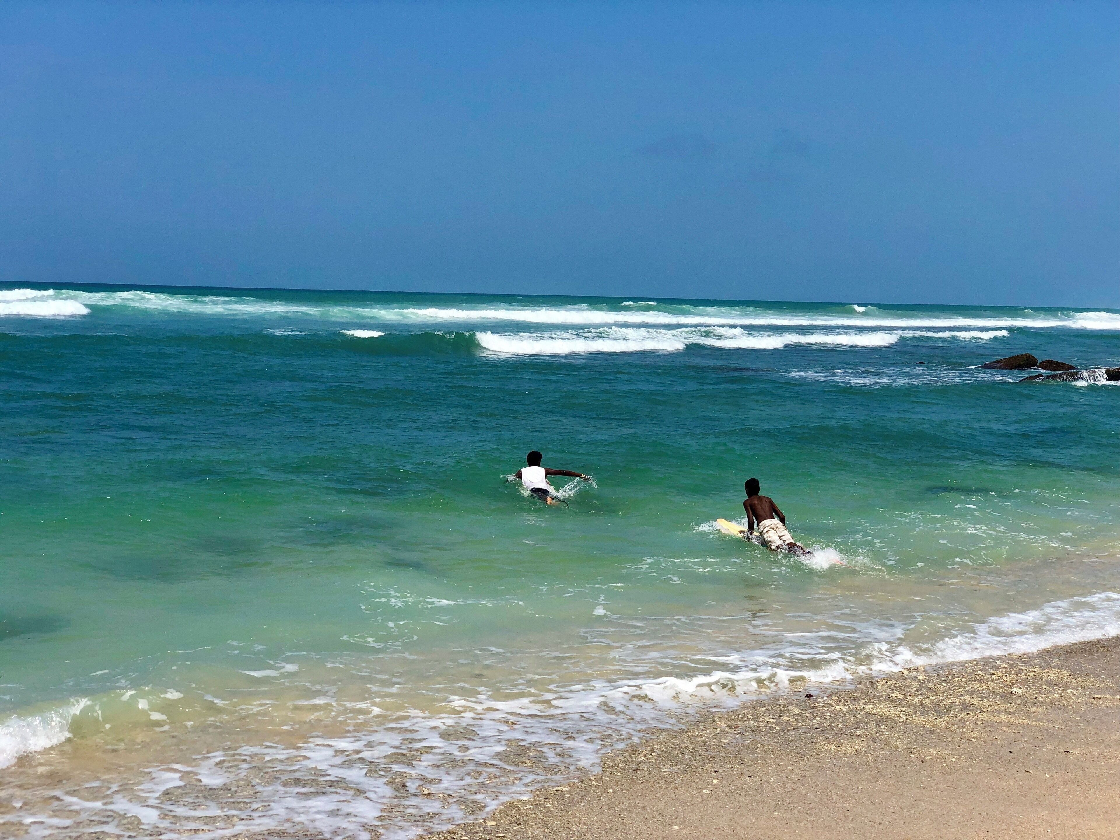 Local kids going out for surfing