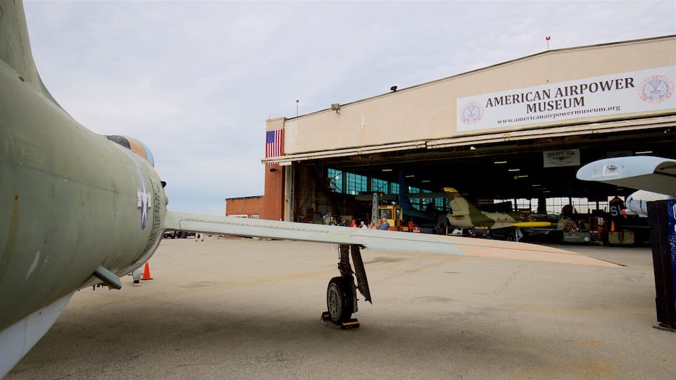 An airplane parked in front of the American Airpower Museum.