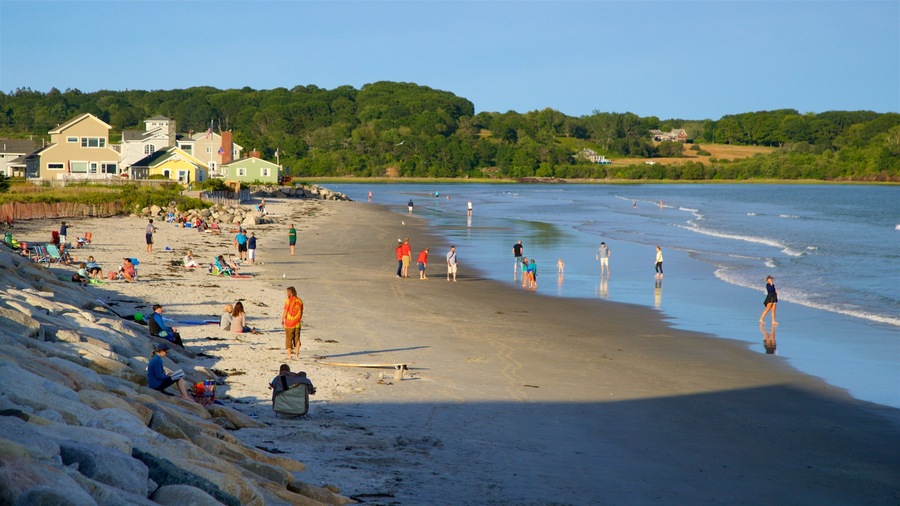 Higgins Beach featuring general coastal views and a sandy beach as well as a small group of people