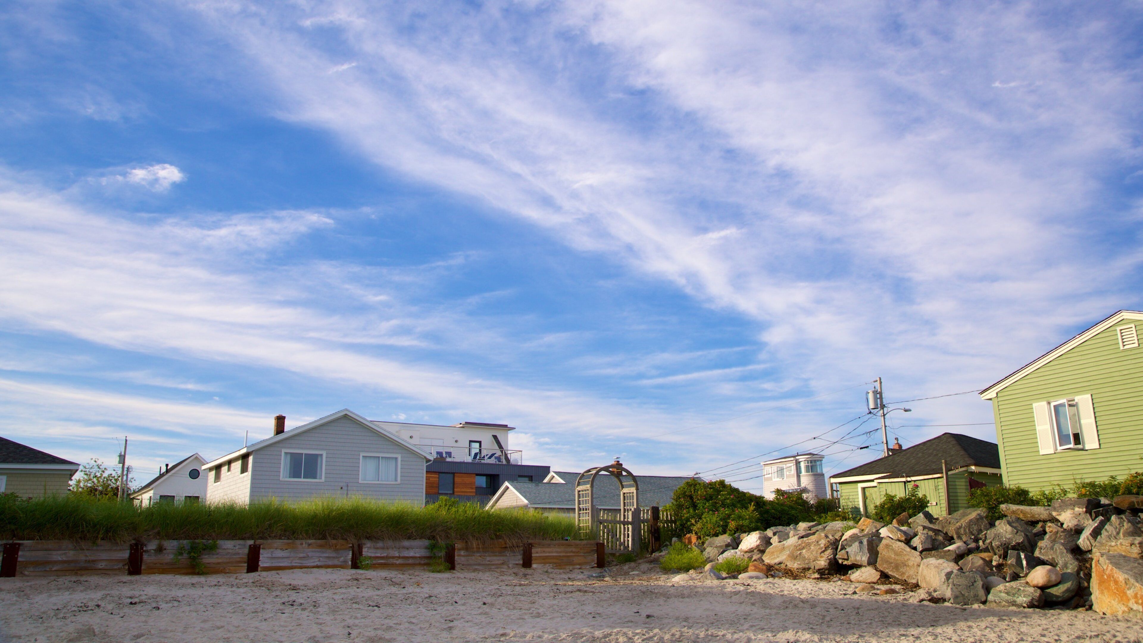 Higgins Beach featuring a sandy beach and a coastal town