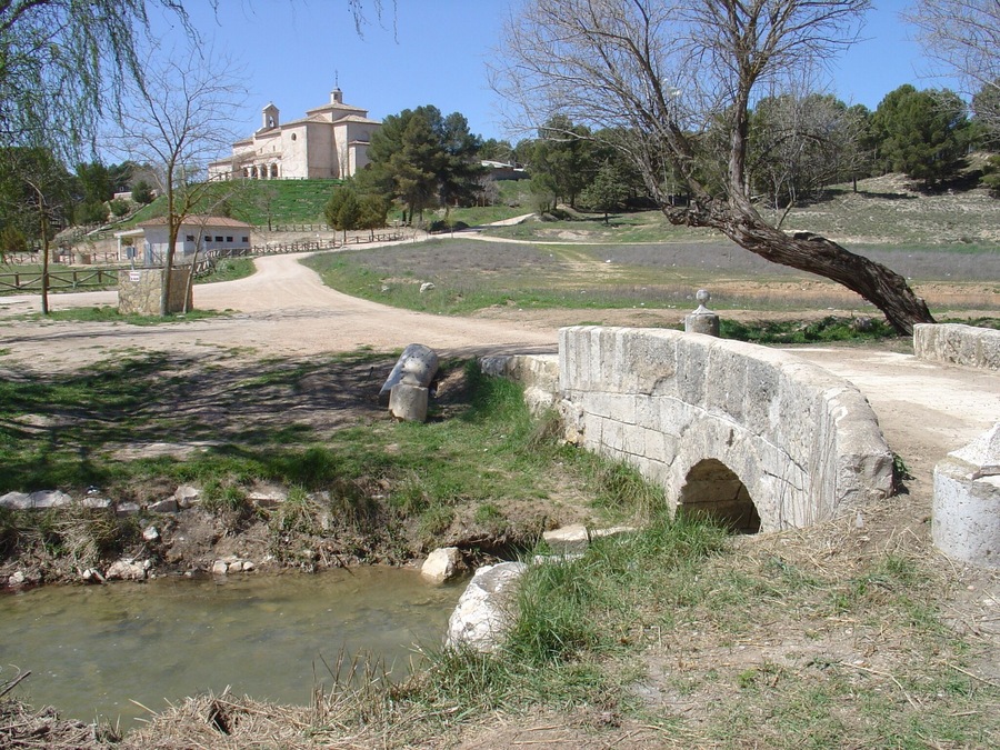 Riansares river, crossing rhe roman bridge with the Riánsares Virgin shrine in the background. Tarancón - Cuenca - Spain