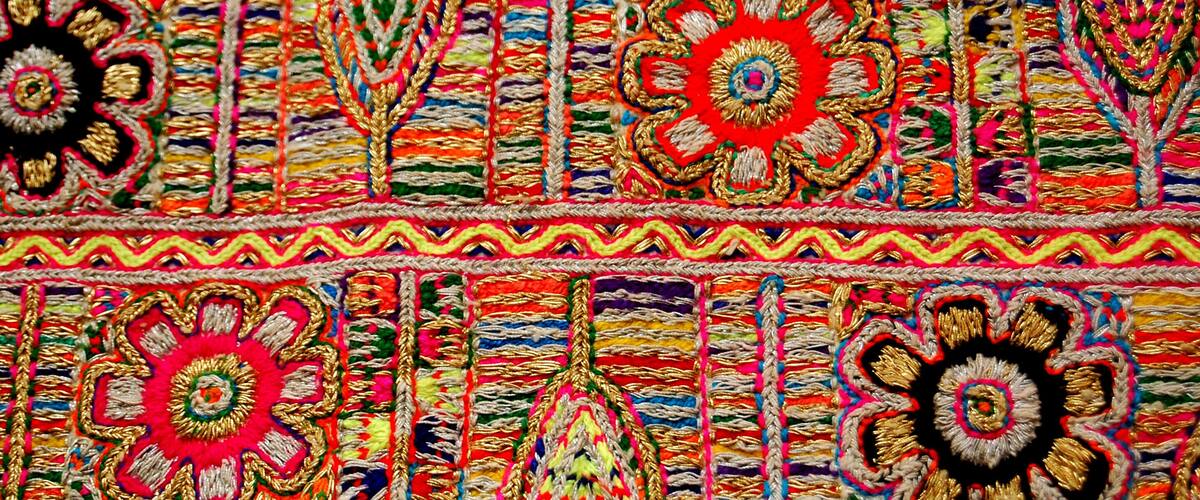 A colorful textile with intricate patterns and floral motifs.