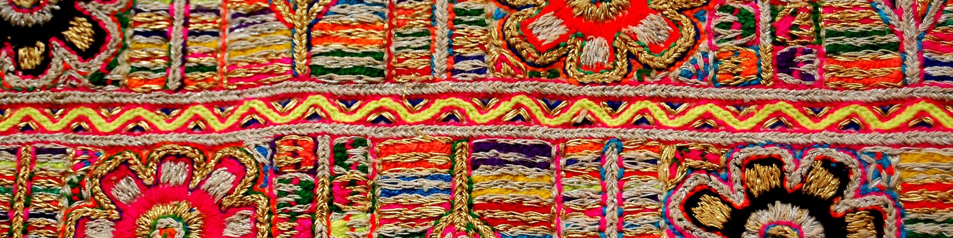 A colorful textile with intricate patterns and floral motifs.