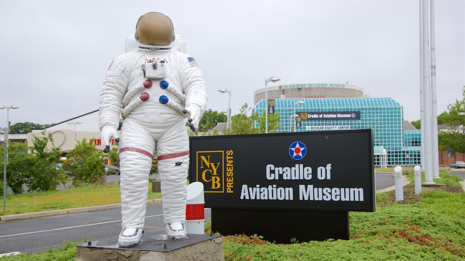 A statue of an astronaut in front of the Cradle of Aviation Museum.