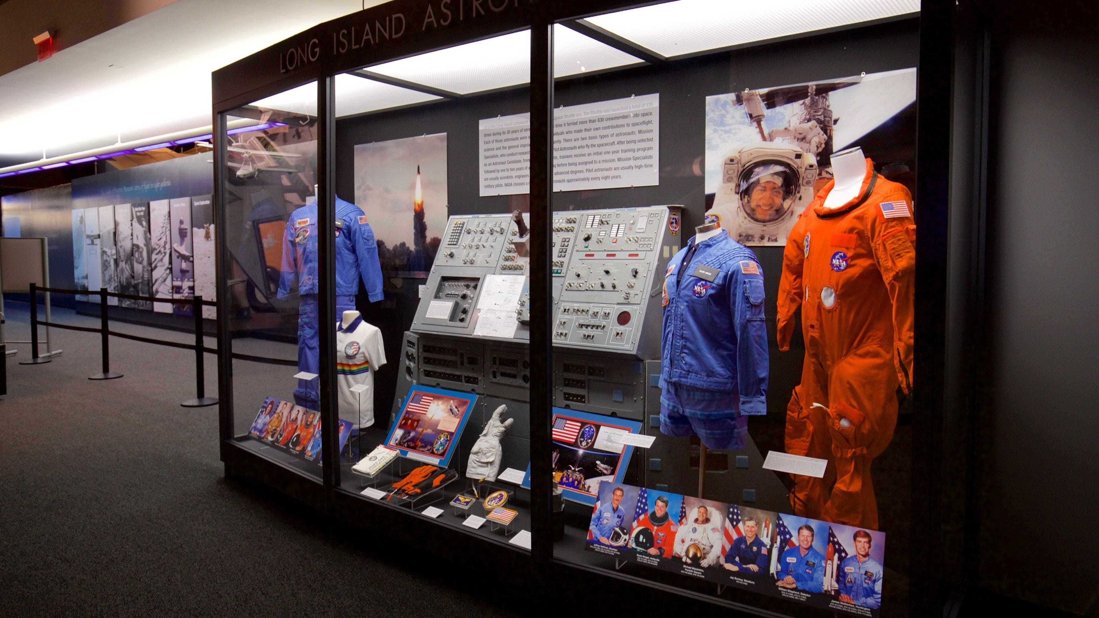A space exhibit with astronaut suits, space shuttle models, and informational displays.