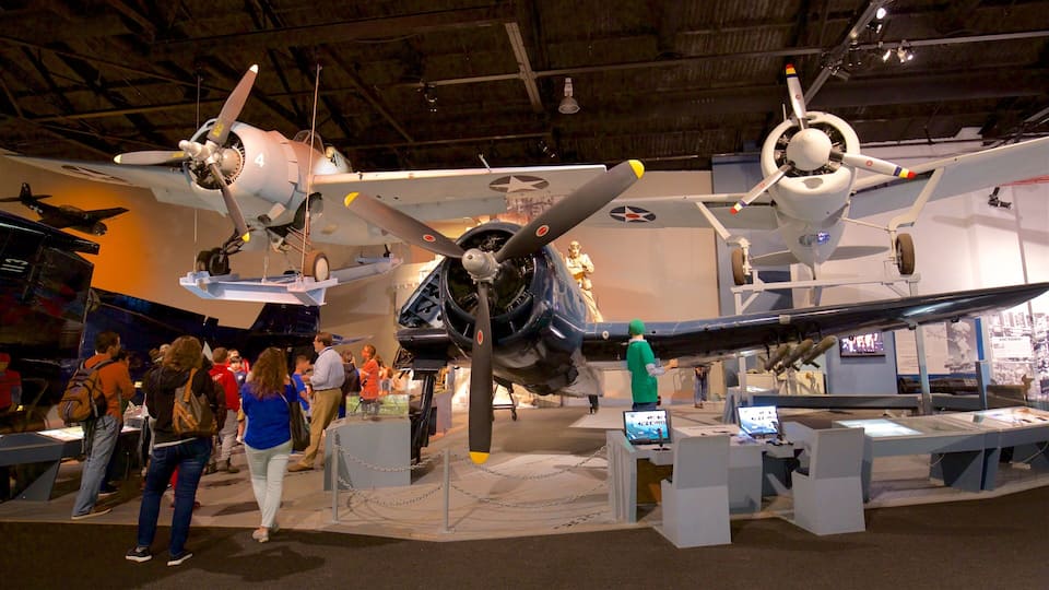 A museum exhibit with multiple aircraft on display, including a fighter jet and a bomber.