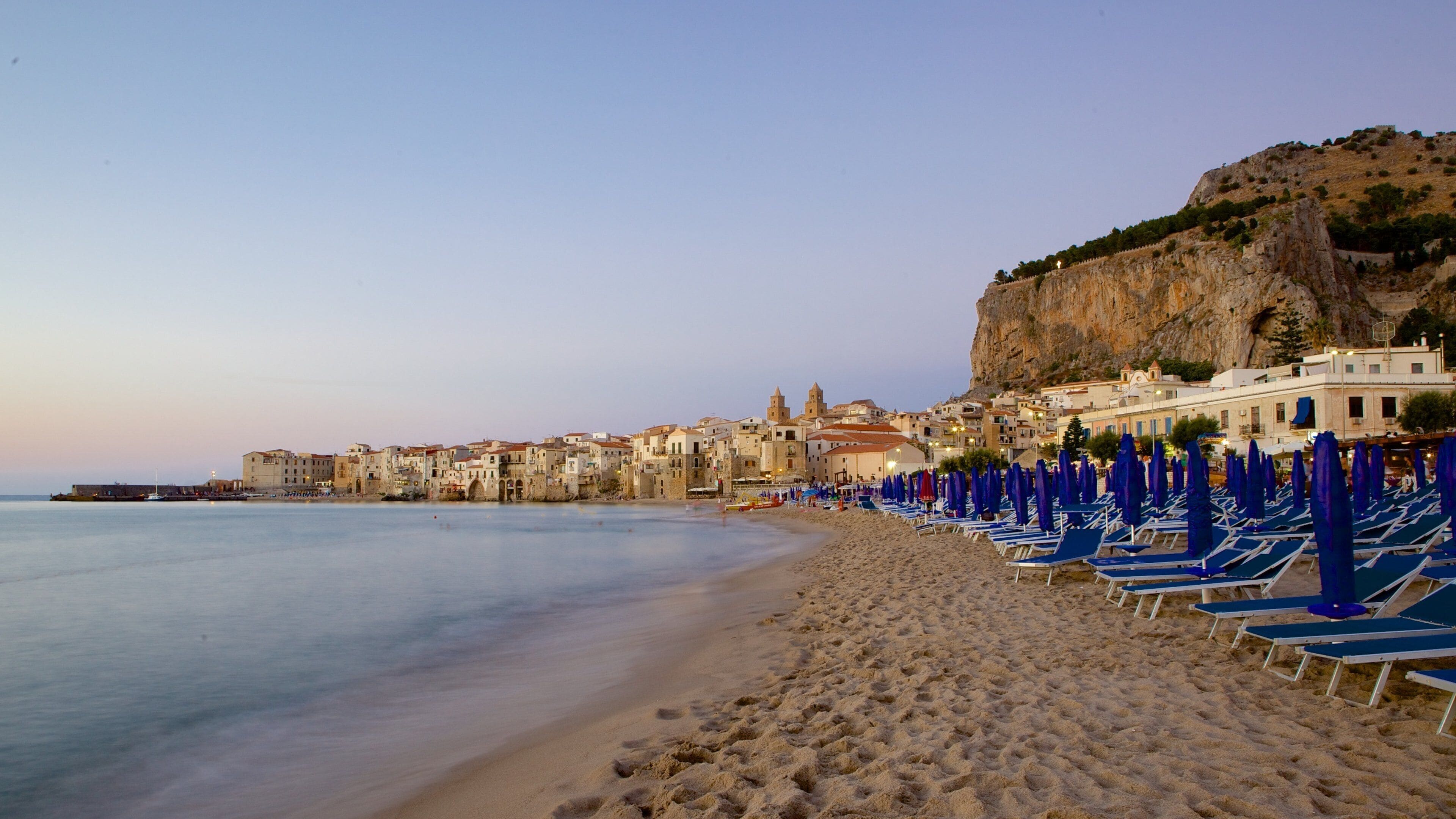 Rocca of Cefalu showing a sunset, a beach and a coastal town