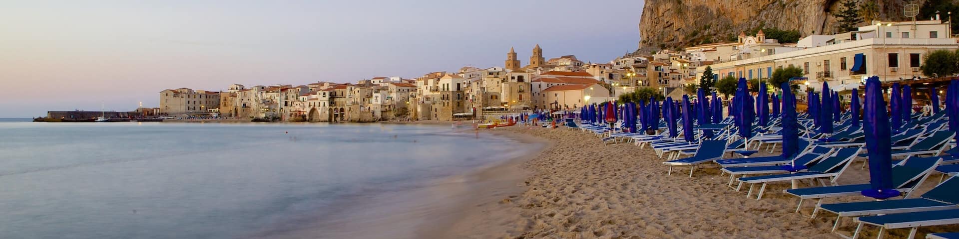 Rocca of Cefalu showing a sunset, a beach and a coastal town