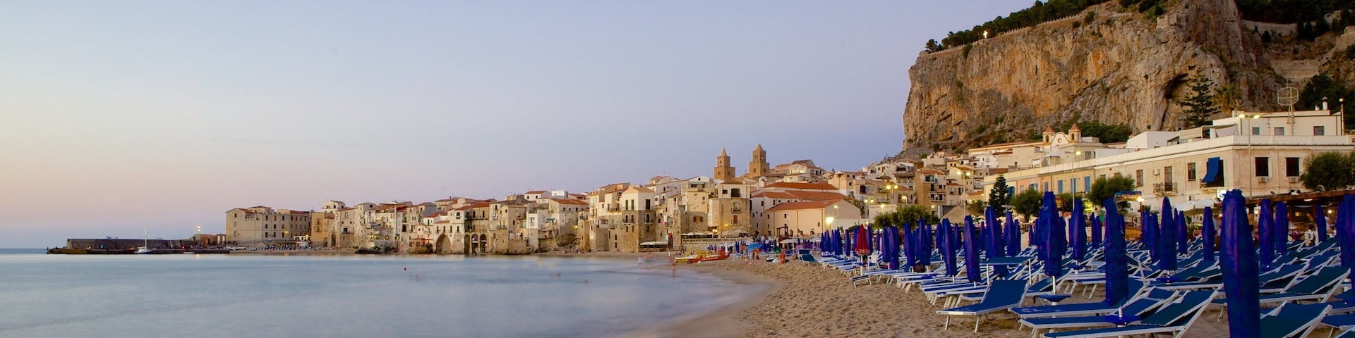 Rocca of Cefalu showing a sunset, a beach and a coastal town