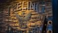 A wooden wall with the text "TEELING DISTILLERY" and a year "2015".