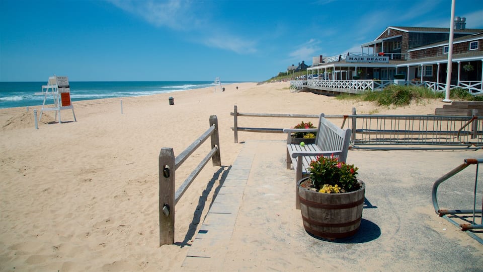 A beach with a wooden fence, a lifeguard stand, a bench, and a building labeled "Main Beach".