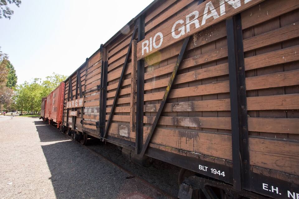 A train car labeled "RIO GRANDE" with the number "BLT 1944" and "E.H. N" visible.