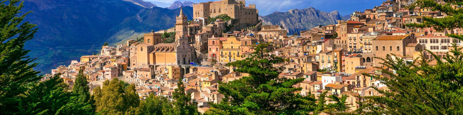 High resolution panorama of Caccamo mountain village in Sicily Italy with medieval castle and cathedral. Scenic wide view of Sicilian landscape for World Print. 14k ultra wide angle stock photo.