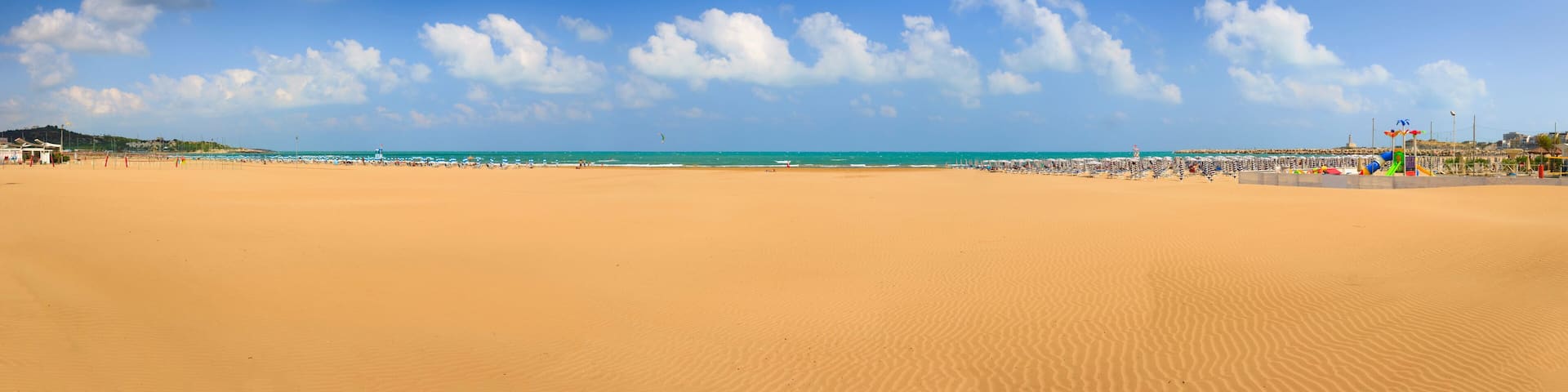 Gargano coast: Bay of Vieste, (Apulia) Italy. Convento or San Lorenzo beach, which is so long that it has two names, is located nearby Vieste and is buzzing with private and public beaches.