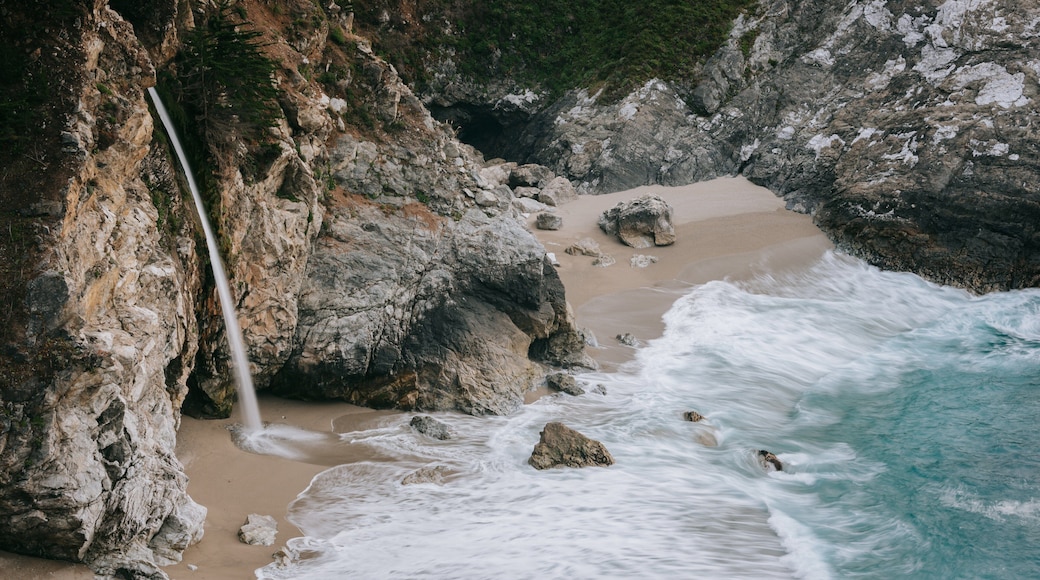 McWay Falls featuring rugged coastline, a waterfall and a sandy beach