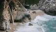 McWay Falls featuring rugged coastline, a waterfall and a sandy beach