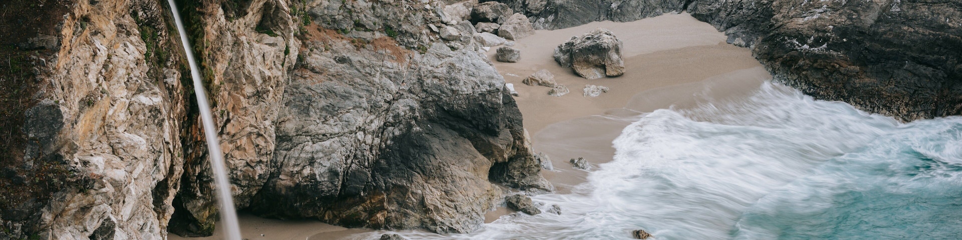 McWay Falls featuring rugged coastline, a waterfall and a sandy beach