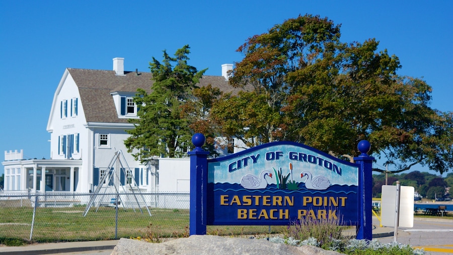A sign for City of Groton Eastern Point Beach Park with a white house in the background.