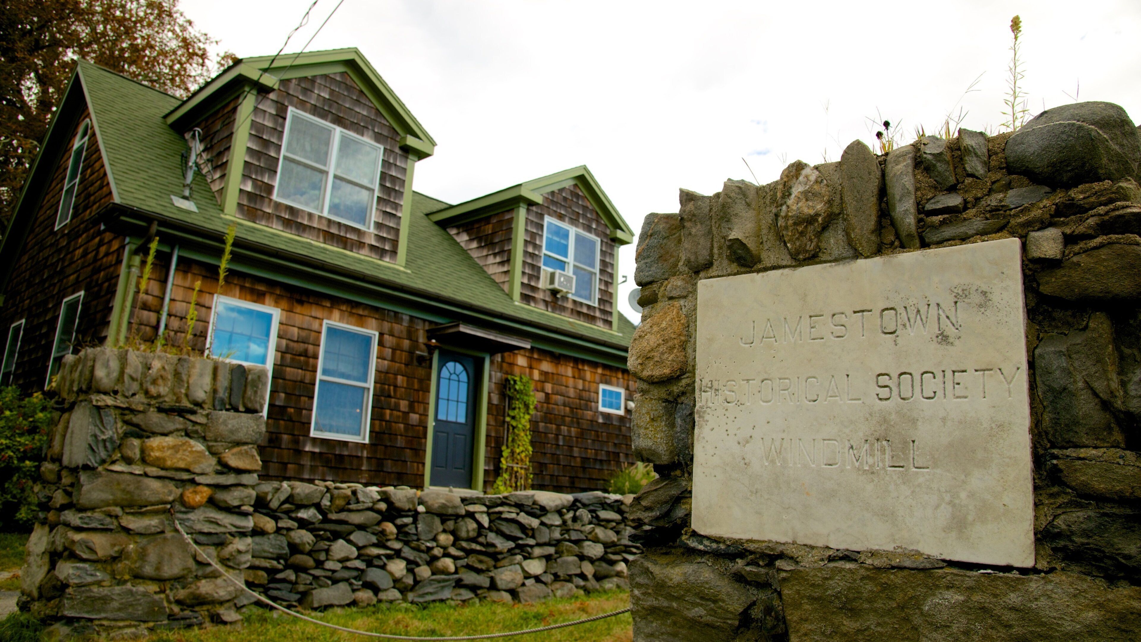 Jamestown Windmill featuring signage, a house and heritage elements