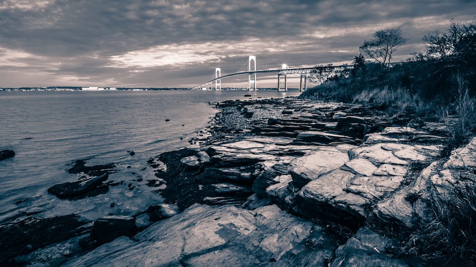 newport bridge at sunset with dramatic sky
