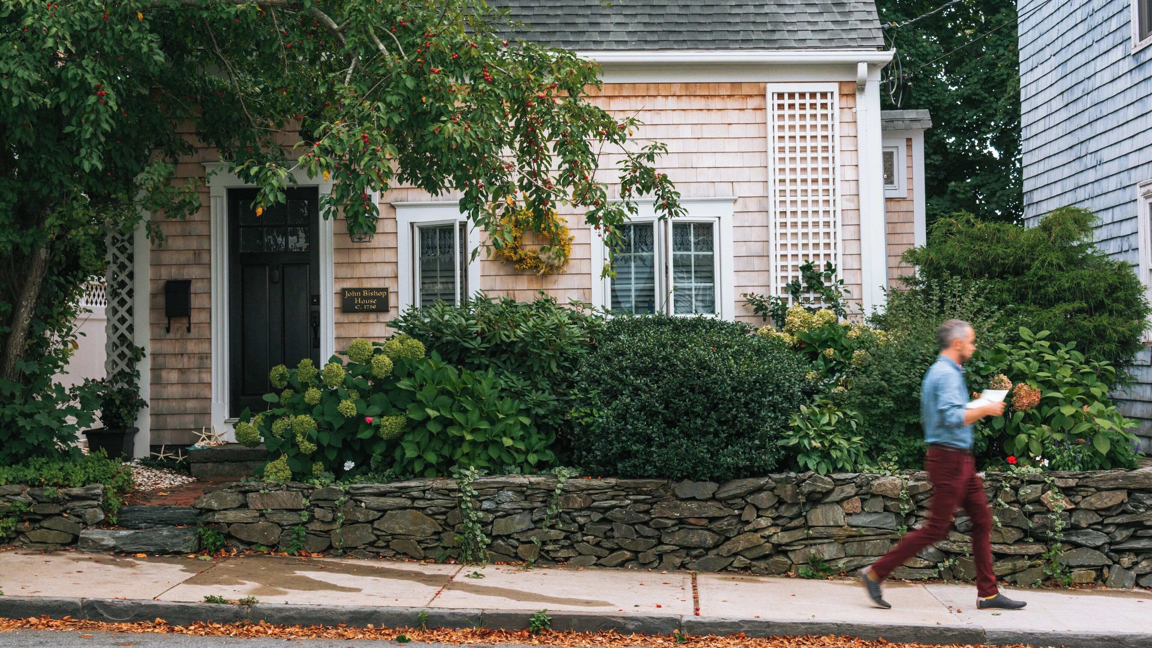 Charming streetscape of Thames Street in Yachting Village, Newport, Rhode Island, showcasing classic architecture and a leisurely stroll