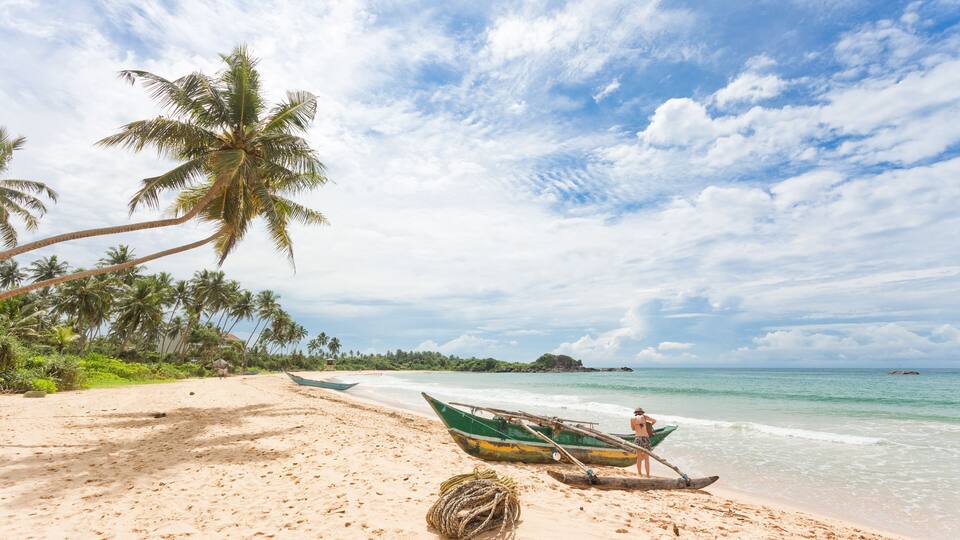 Balapitiya, Sri Lanka - A woman preparing for a canoe tour at the beach of Balapitiya