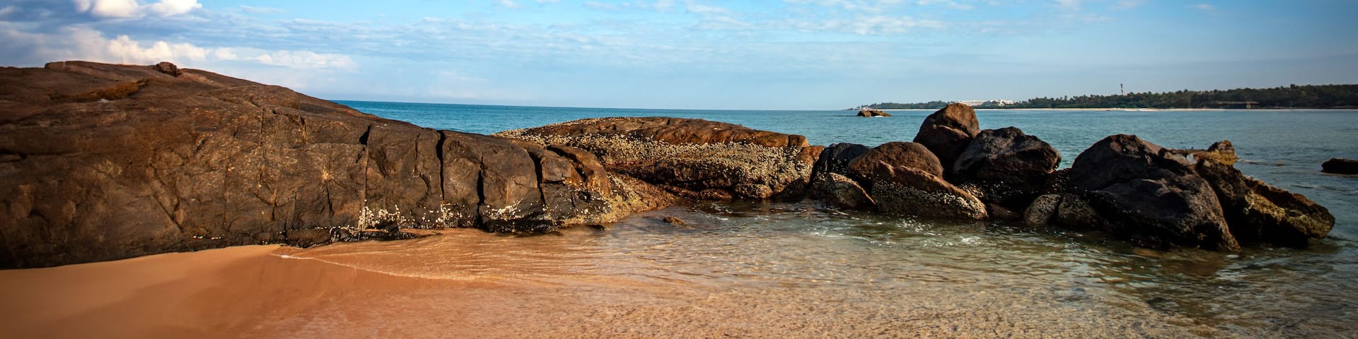 sea and rocks with white clouds in the blue sky of southern Sri Lanka beach.