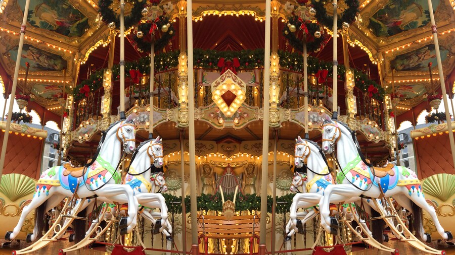 festive merry-go-round carousel with horses and lights in Frankfurt during the Christmas market, Christmas holiday