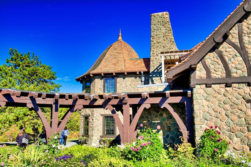 A stone building with a tiled roof and wooden beams.