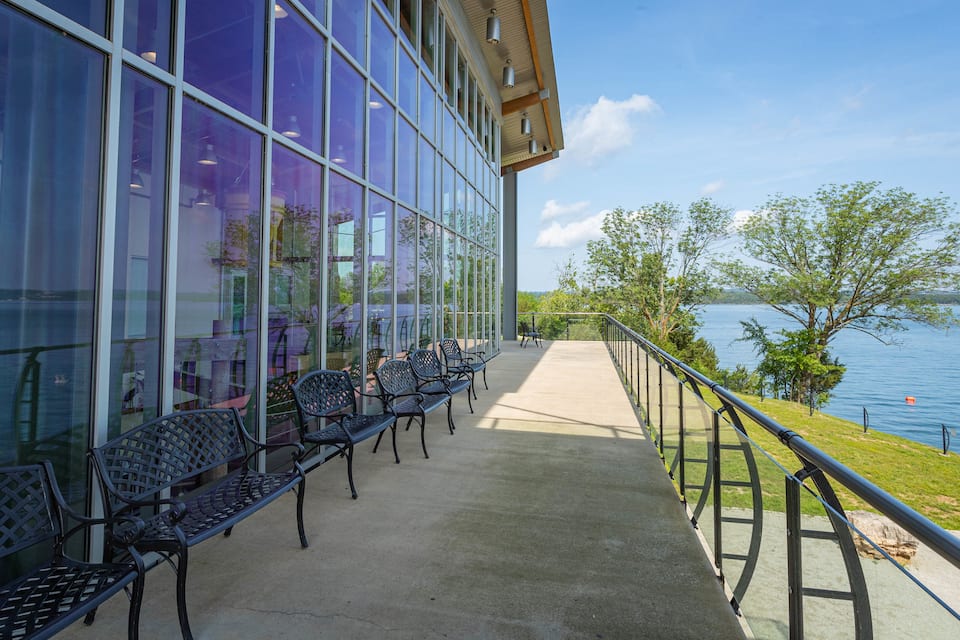 A waterfront patio with outdoor seating and a view of the lake.