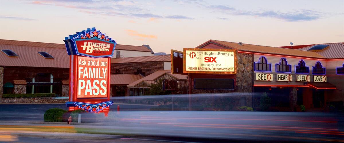 Hughes Brothers Theatre featuring signage and a sunset