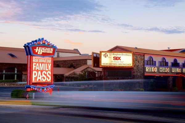 Hughes Brothers Theatre featuring signage and a sunset