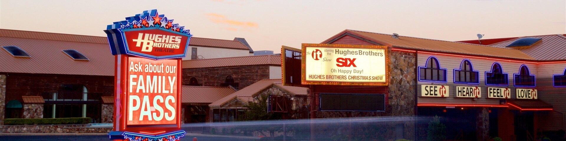 Hughes Brothers Theatre featuring signage and a sunset