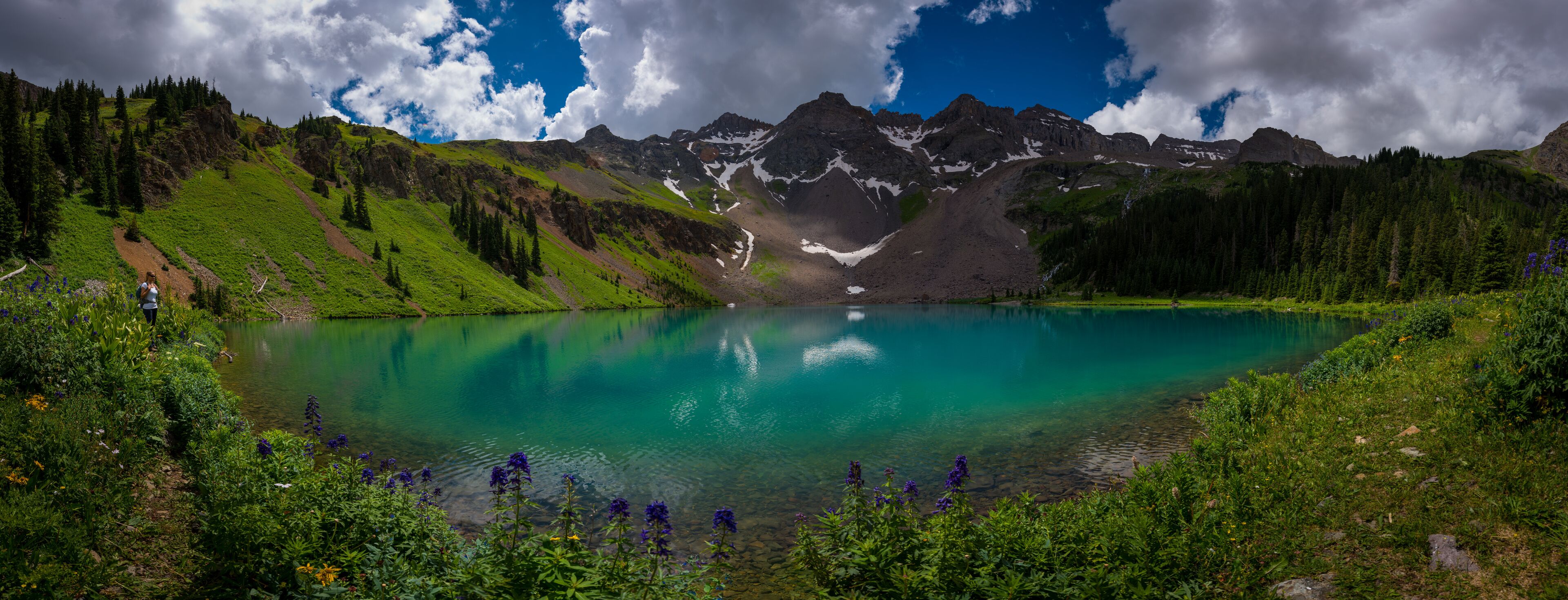 Hiker looks at Blue Lake  Ridgway Colorado