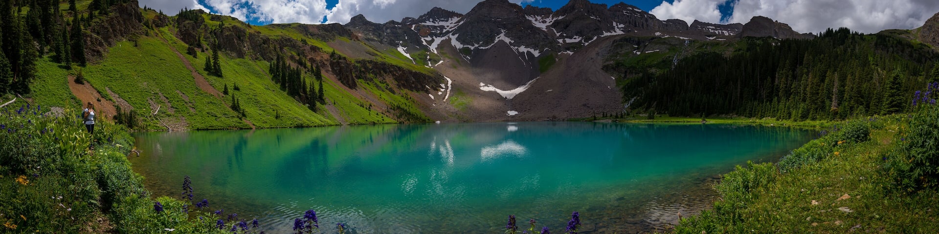 Hiker looks at Blue Lake Ridgway Colorado