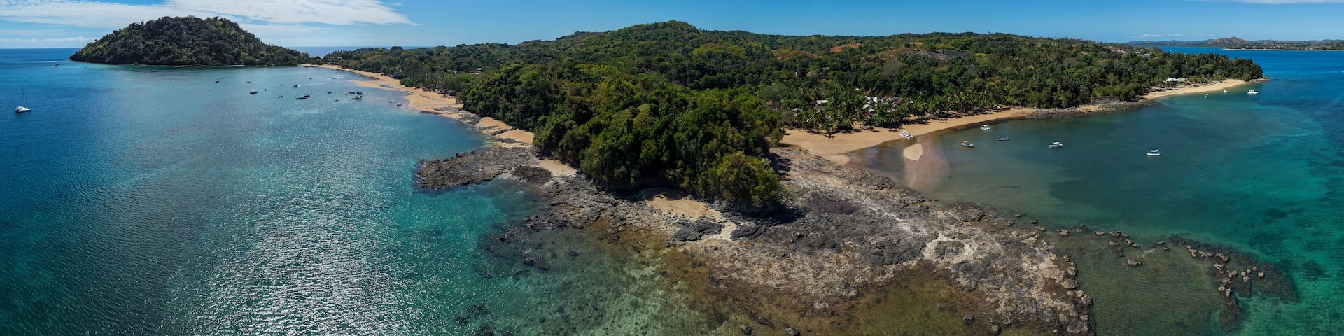 Aerial 180° panorama of Sakatia Island, Nosy Be, Madagascar – turquoise sea, white sand beach, palm trees, and tropical paradise in the Indian Ocean.