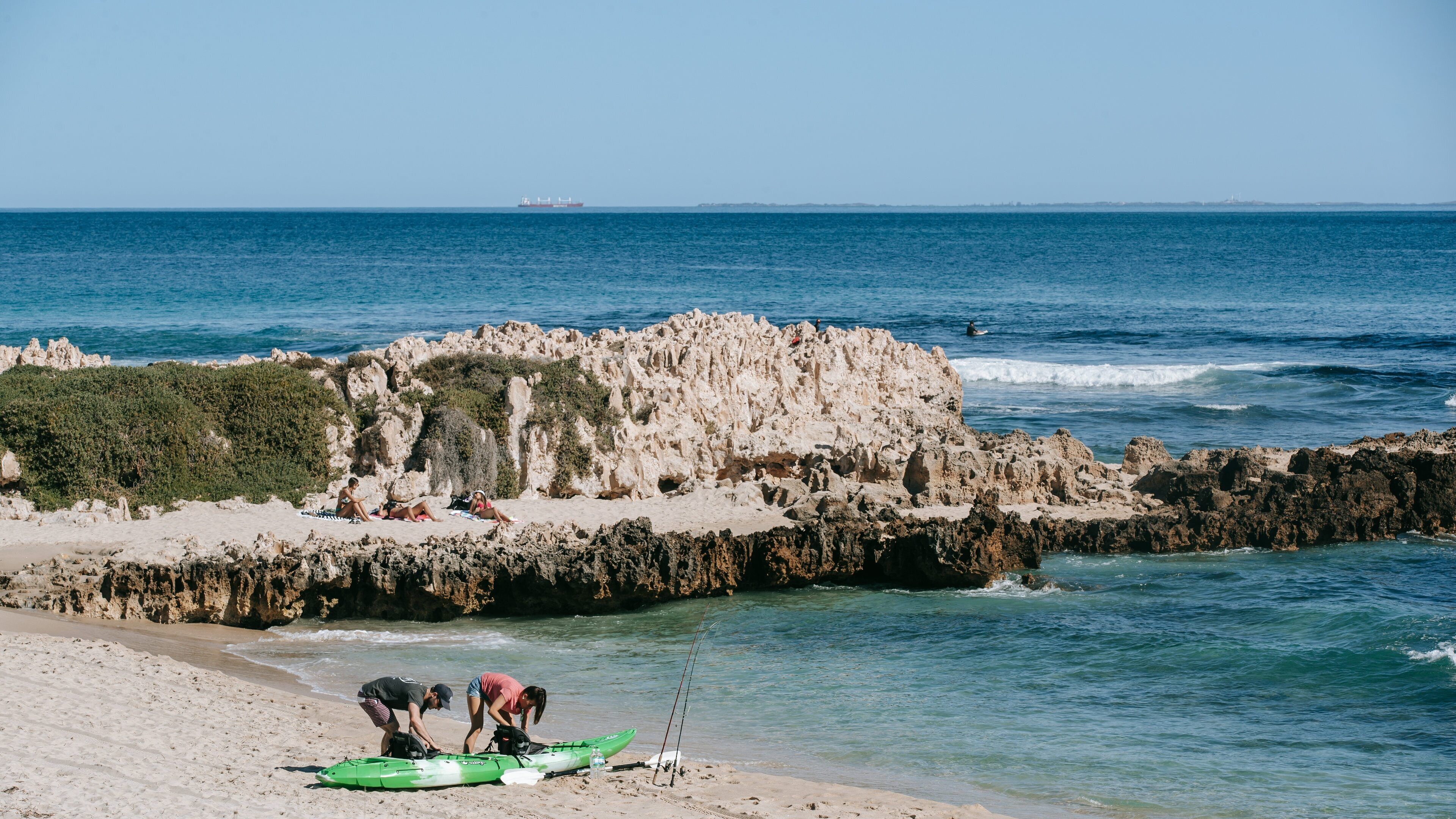 Trigg Beach which includes general coastal views, a sandy beach and rugged coastline