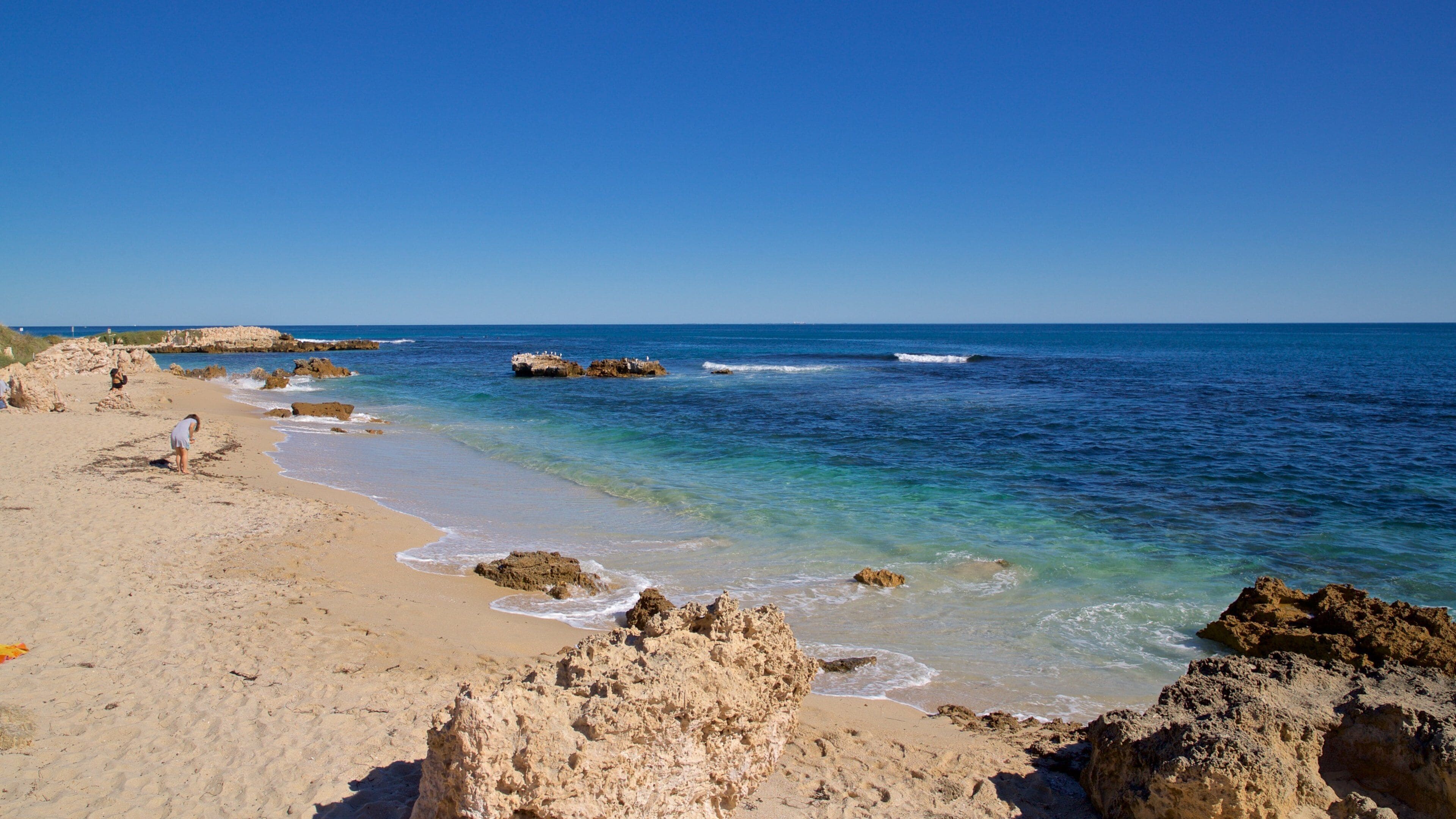 Trigg Beach showing rugged coastline, a sandy beach and general coastal views