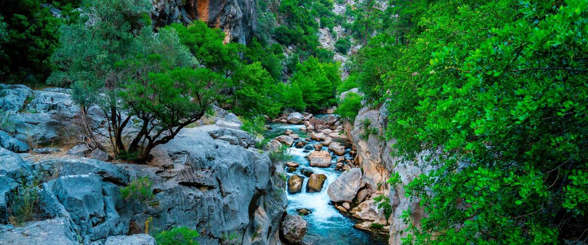 Yazılı Canyon Nature Park has a remarkable structure with its stones in the lake, green views and sparkling flowing waters. Isparta, Turkey.