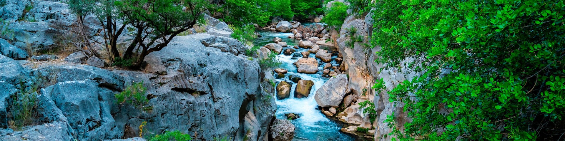Yazılı Canyon Nature Park has a remarkable structure with its stones in the lake, green views and sparkling flowing waters. Isparta, Turkey.