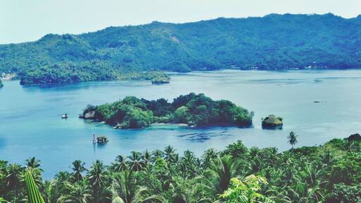- Lembeh Straits -
This strait is so beautiful. Lots of tiny islands, cliffs, beautiful view and of course beautiful and unique marine ecology.
There are few beautiful resorts that will provide you with nice accommodation, such as BlackSands Retreat, Dabirahe @ Lembeh Hills and Kungkungan Bay resort.
These resorts will help you to explore the beautiful underwater world of Lembeh Strait.
Getting here is very easy as it's connected by road from the capital of North Sulawesi, Manado. It's about one and a half hour ride from Manado to here.