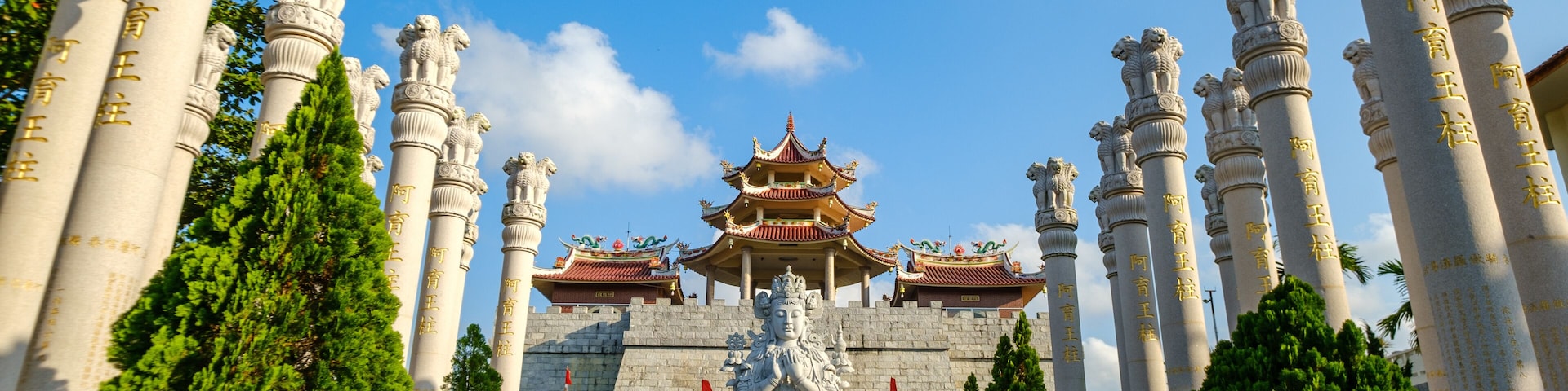 A temple with ornate columns and a traditional pagoda-style roof.