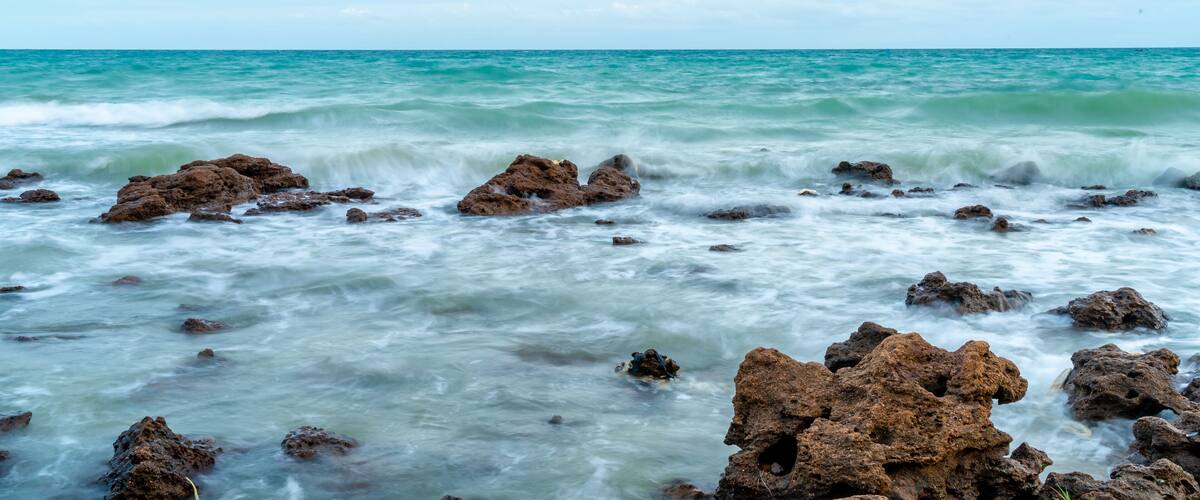 A rocky shoreline with waves crashing against the rocks.
