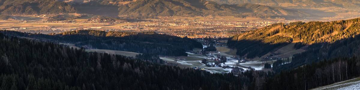 Panorama of Spierlberg-city in Austria with Red Bull Ring race circuit with Alps covered with snow in background.